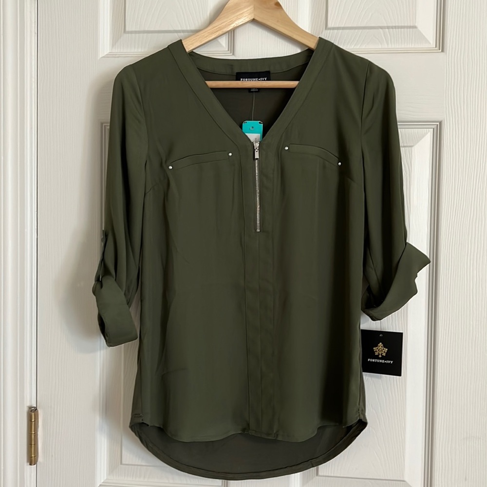 Brand new with tags.  Olive green top with silver zipper and roll up sleeves.